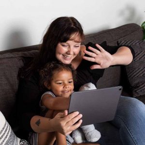 Mother and daughter using a tablet for a video call