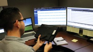 Lakeland employee at a desk plugging in a modem