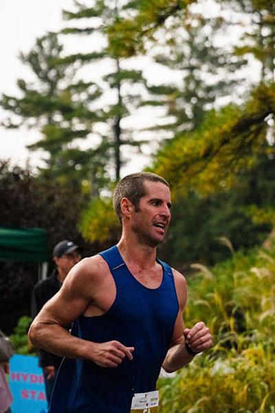 Bracebridge resident and Lakeland employee Fraser Burgess passes a water station during a marathon