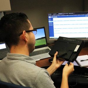 A Lakeland employee plugs in a router
