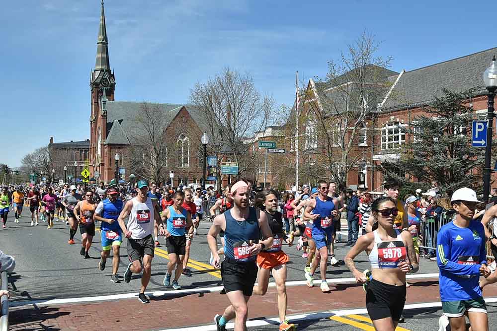 Lakeland Networks employee Fraser Burgess crosses the start line at the 2022 Boston Marathon along with other competitors.