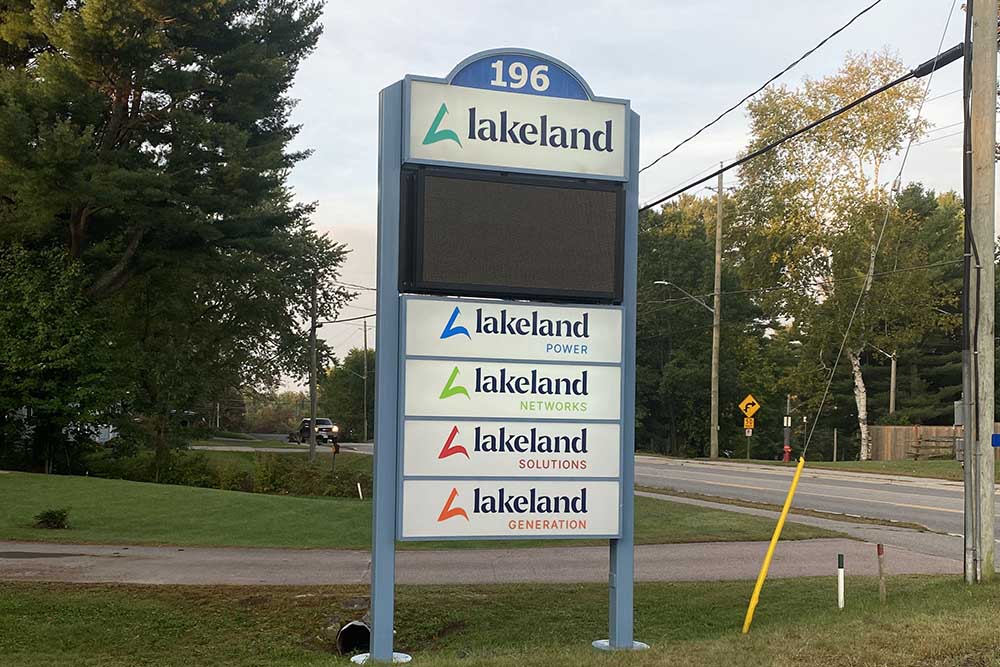 A photo of the sign in front of Lakeland Holdings' office in Bracebridge, with the logos of Lakeland Power, Lakeland Networks, Lakeland Solutions and Lakeland Generation