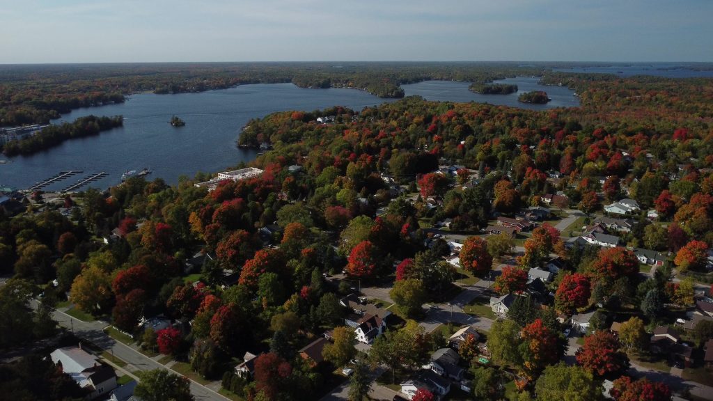Aerial view of a Muskoka town in the fall including town streets and the lake