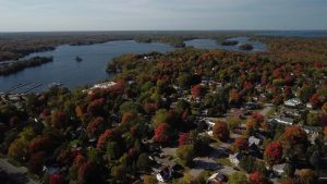 Drone view of Muskoka lakeside neighbourhood in the fall time