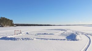 Hockey net on frozen and snowy Muskoka lake