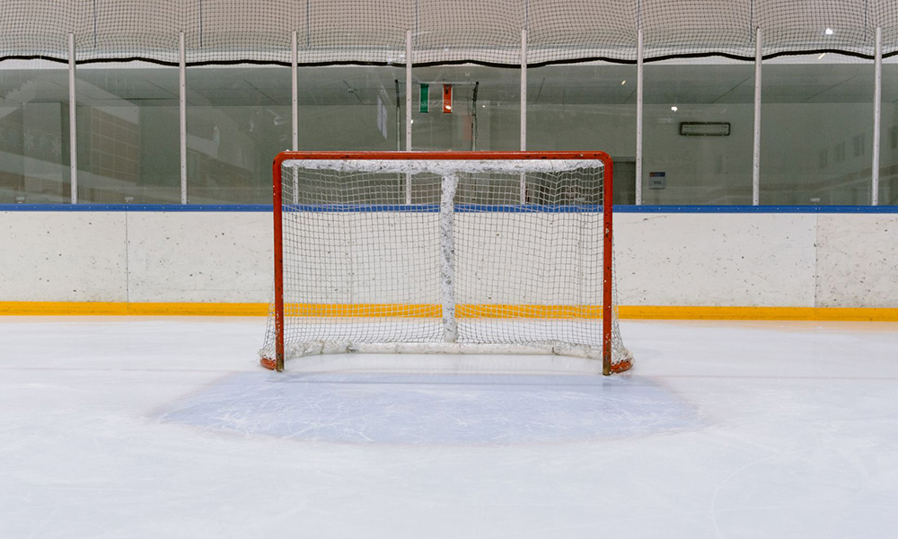 Empty red hockey net in an arena