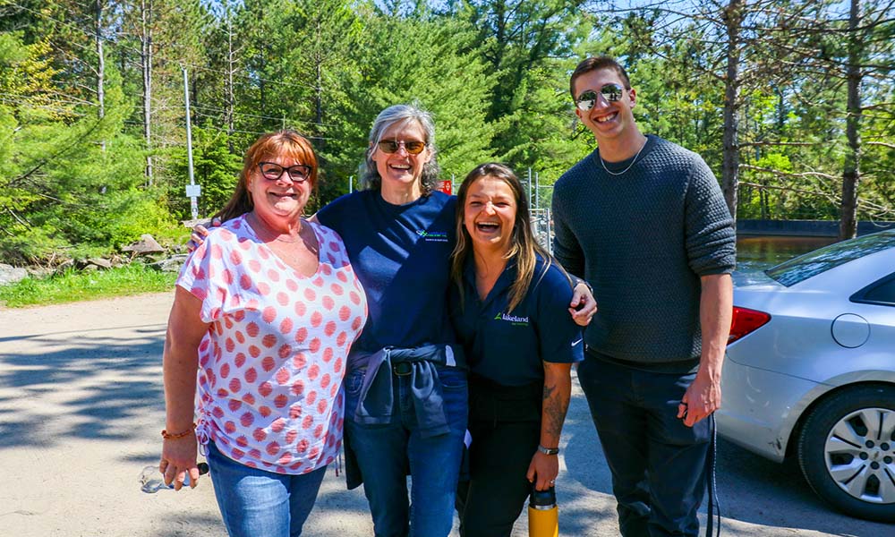 Group of 4 Lakeland employees smiling together.